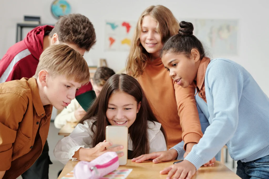 group of children looking at a phone