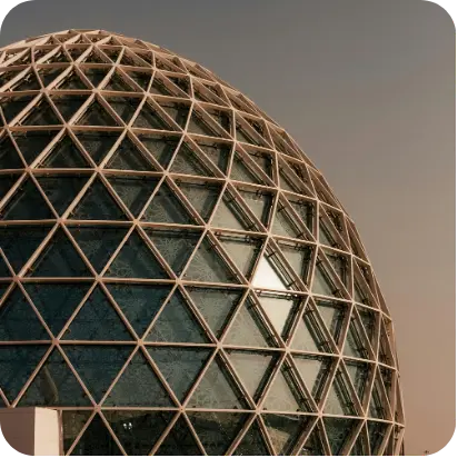 Glass geodesic dome with triangular panels.