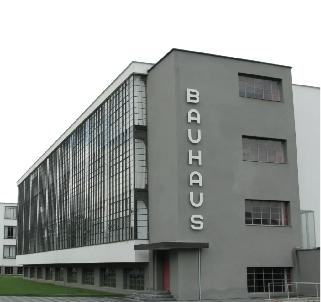Bauhaus school building with large glass windows and the word “BAUHAUS” written vertically on the facade.