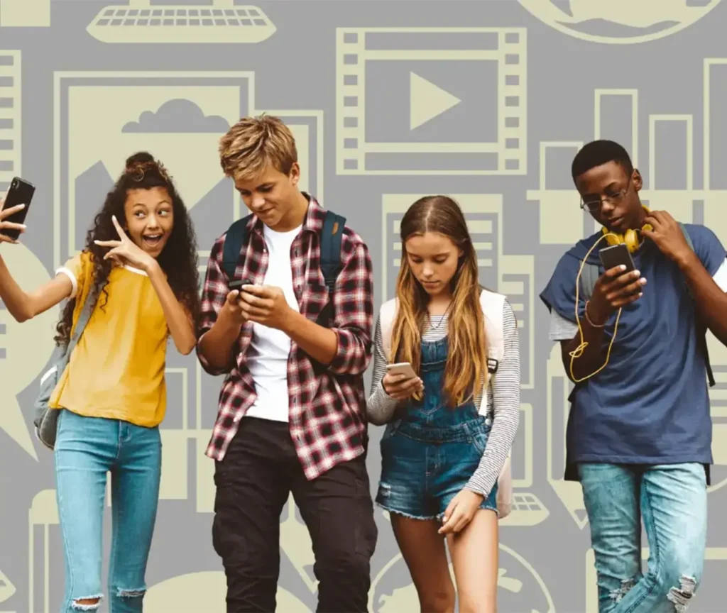 Group of four teenagers looking at their phones against a background of media icons