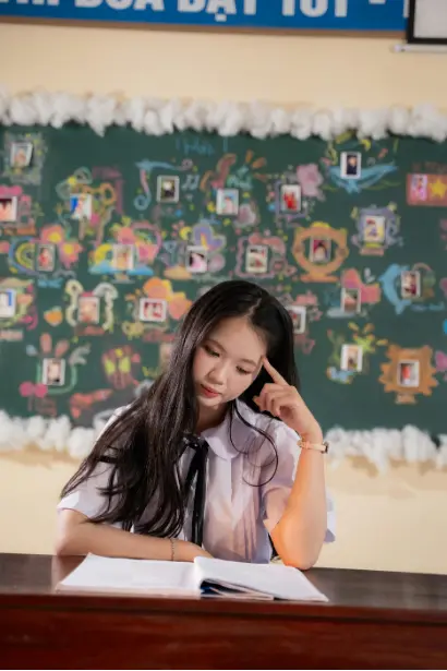 Student sitting at a desk reading and thinking carefully during a classroom task