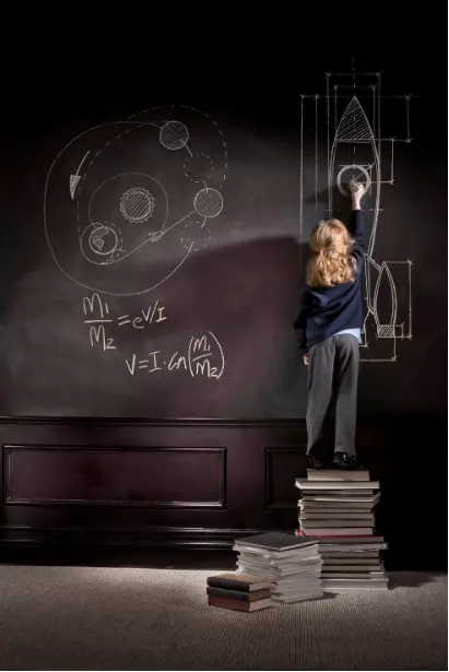 Child standing on books writing ideas and formulas on a blackboard, representing thinking, problem-solving, and deep learning