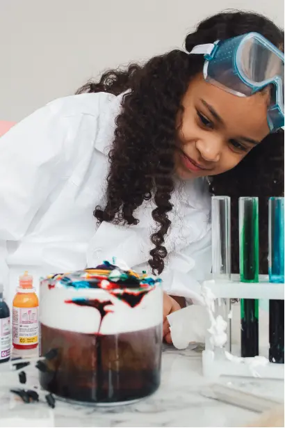 Child conducting a science experiment with colorful liquids, showing curiosity, exploration, and intrinsic motivation in learning